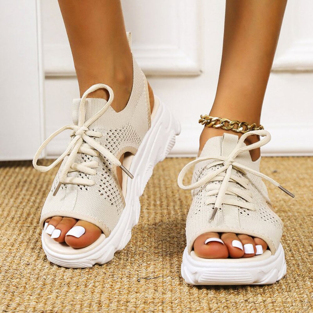Effie sandals in beige styled with a flowy summer dress on a woman outdoors