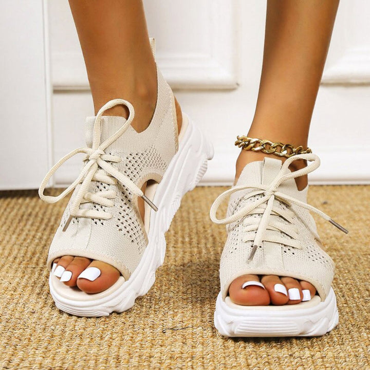 Effie sandals in beige styled with a flowy summer dress on a woman outdoors