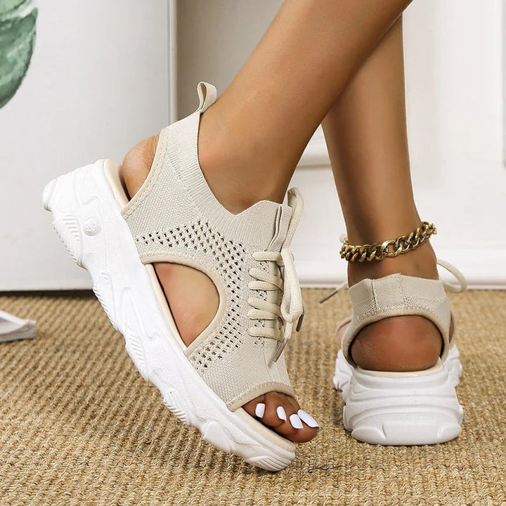 Woman wearing Effie cushioned sandals in beige paired with linen shorts