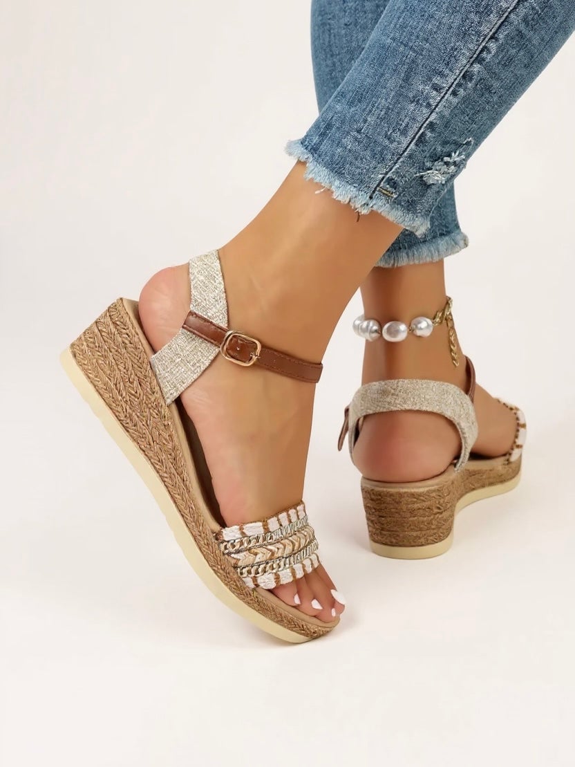 Close-up of Effie beige wedge sandals showing intricately woven strap detailing