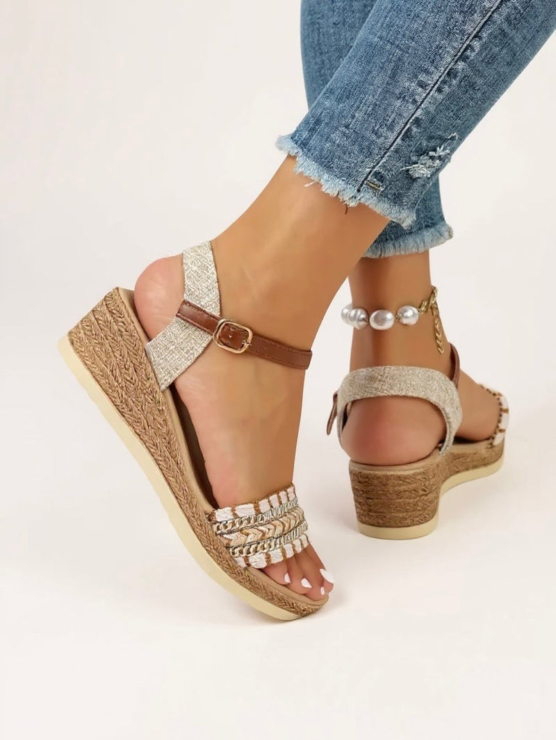 Close-up of Effie beige wedge sandals showing intricately woven strap detailing