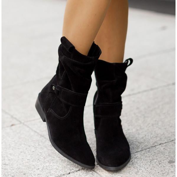 Model walking in Eileen ankle boots in Texan Brown on a city sidewalk