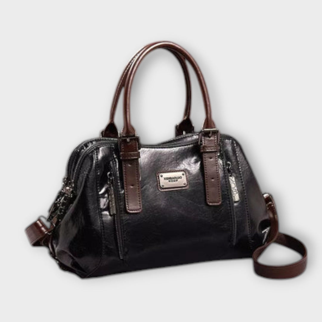Close-up of Eirunn handbag hardware and strap attachment detail