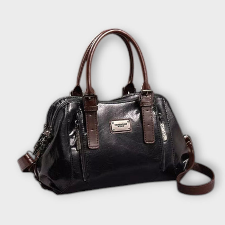 Close-up of Eirunn handbag hardware and strap attachment detail