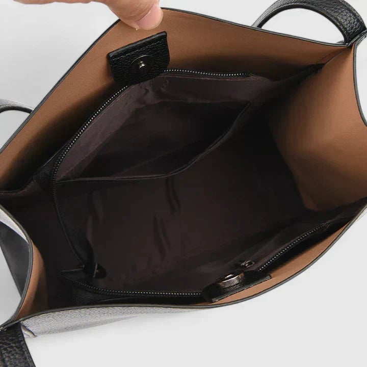 Eirunn structured handbag in brown with clean lines and shoulder straps on a neutral background