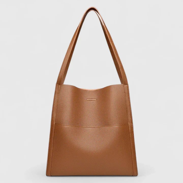 Eirunn structured handbag in gray with comfortable shoulder straps laid flat on a light surface