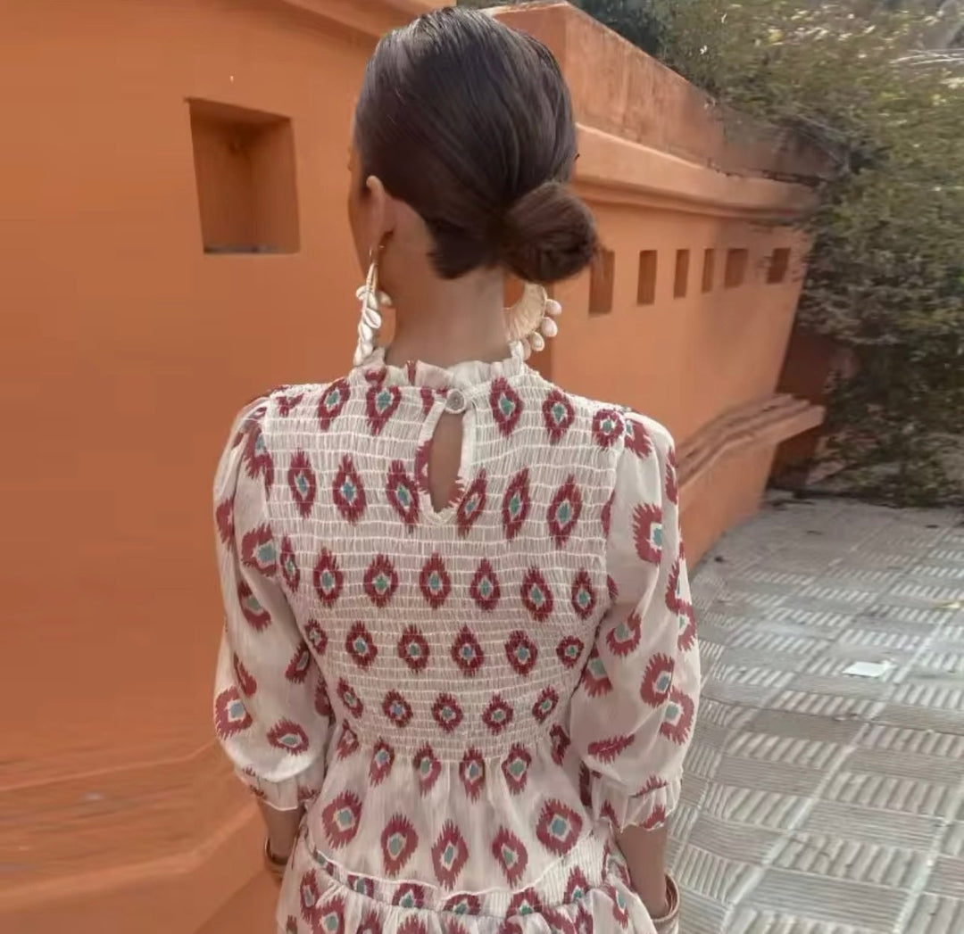 Close-up of the Elara dress neckline and sleeve detail in white, showing feminine and balanced upper-body design