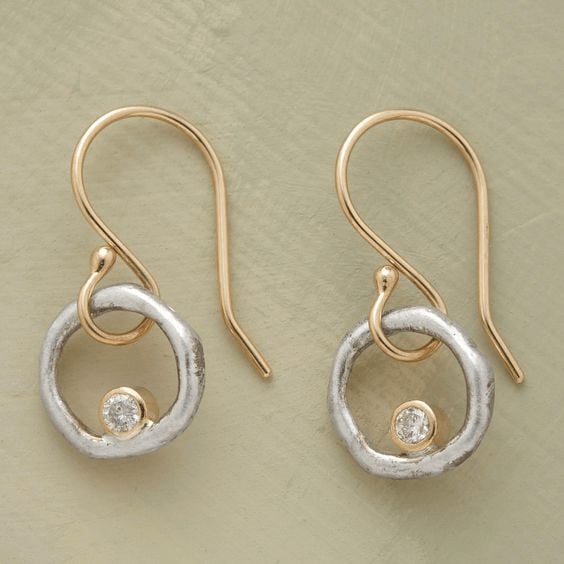 Vintage gold and silver zirconia drop earrings with two-tone finish and sparkling stones, shown on a clean background