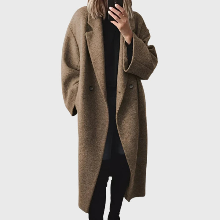 Close-up detail of the Elda longline overcoat showing soft fabric texture and secure front closure