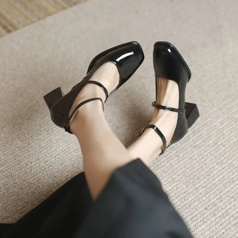 Celeste black patent mary jane pump showing square toe and adjustable ankle strap buckle detail