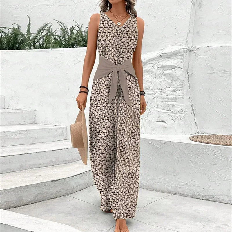 Woman wearing a beige sleeveless jumpsuit with a round neckline and flattering feminine silhouette