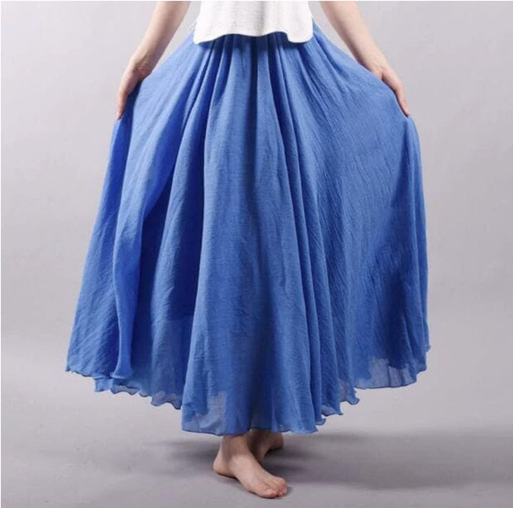 Model wearing the Eliana flowy summer skirt in blue, showing the long relaxed silhouette