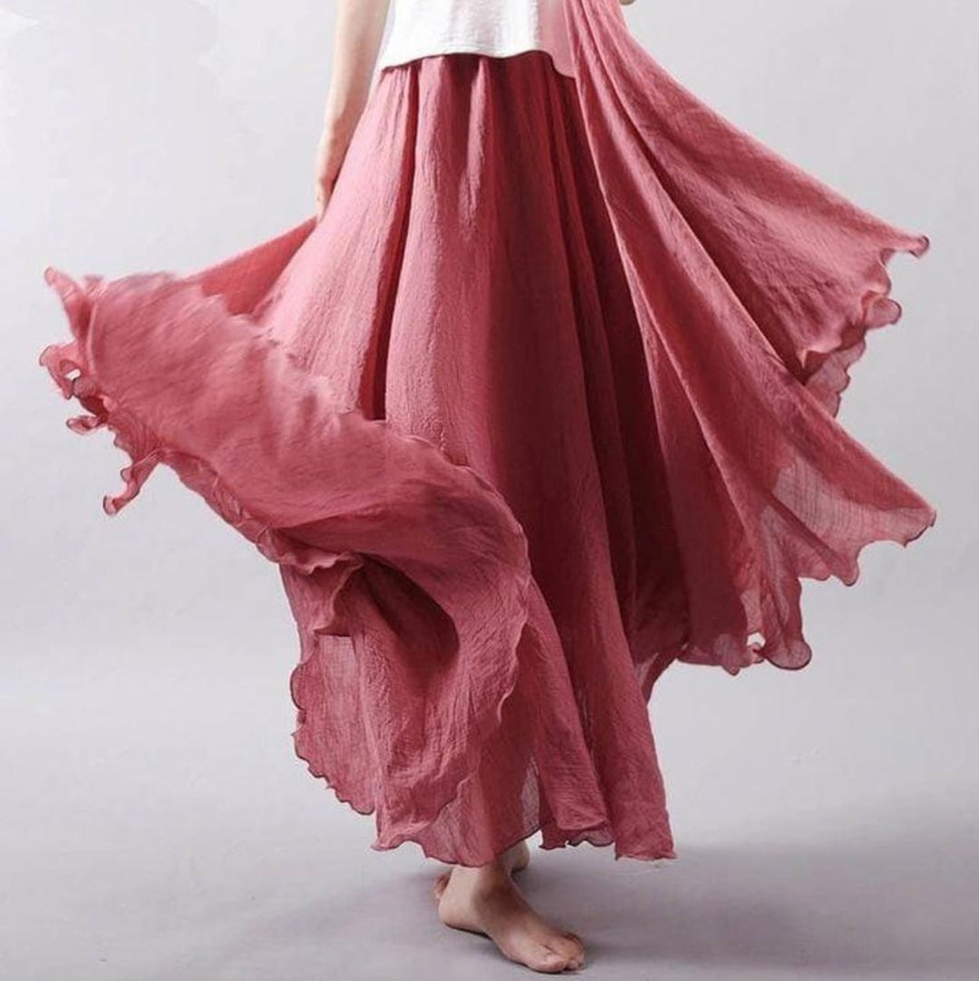 Model wearing the Eliana flowy skirt in dark pink, highlighting graceful movement and fit