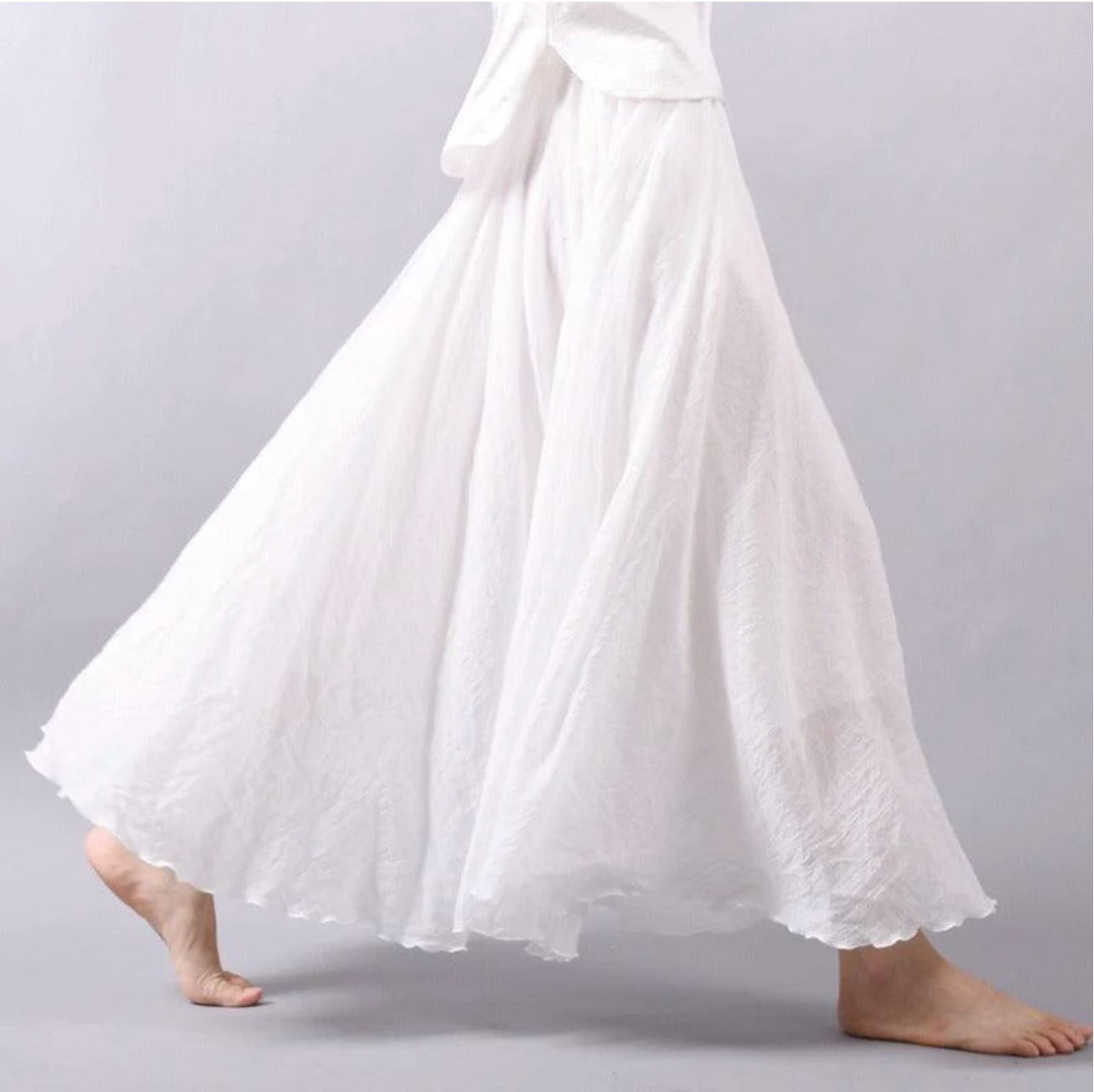 Model wearing the Eliana flowy skirt in white, styled for a casual summer daytime look
