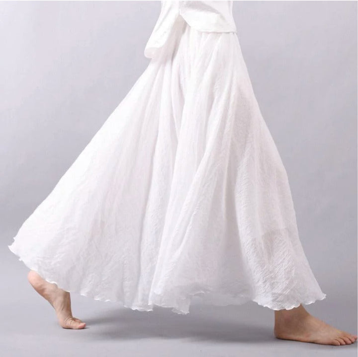 Model wearing the Eliana flowy skirt in white, styled for a casual summer daytime look