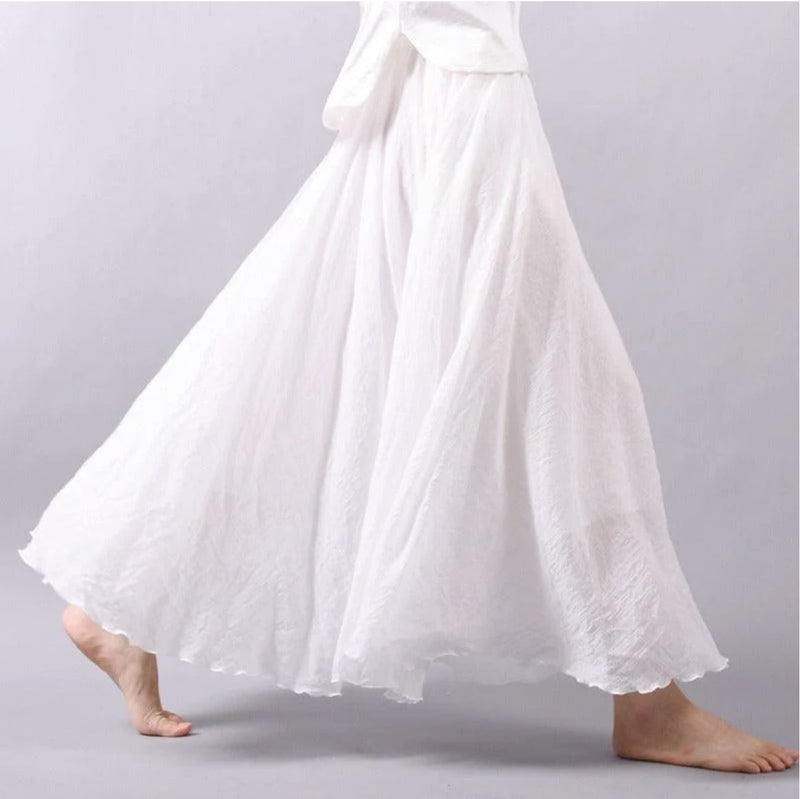 Model wearing the Eliana flowy skirt in white, styled for a casual summer daytime look