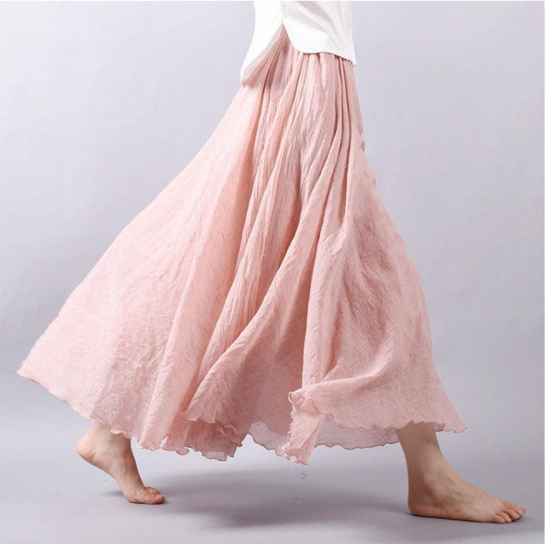 Model wearing the Eliana flowy skirt in light pink, showcasing the breathable flowing fabric