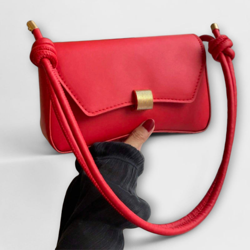Elida shoulder bag in beige displayed at a slight angle highlighting its structured silhouette
