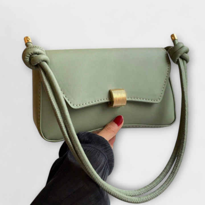 Close-up of the Elida shoulder bag strap and hardware detail in green