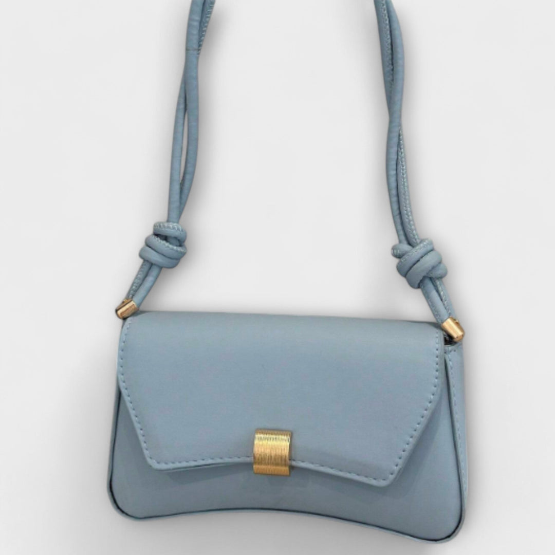 Side profile of the Elida green shoulder bag showcasing its slim lightweight design