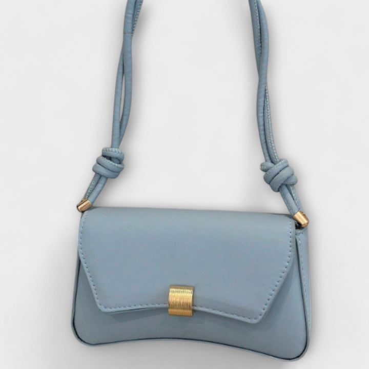 Side profile of the Elida green shoulder bag showcasing its slim lightweight design