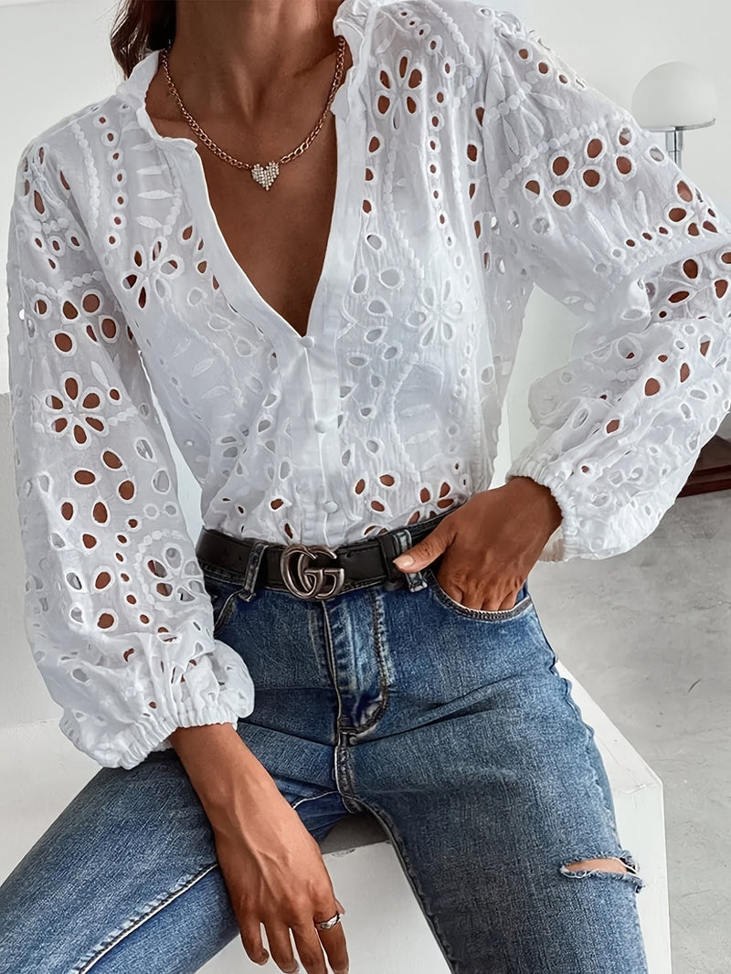 Front view of a white floral long-sleeve blouse with delicate embroidery and openwork detailing