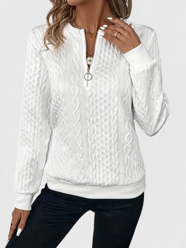 Woman wearing the Elise sophisticated sweater in white, showcasing its clean lines and flattering silhouette