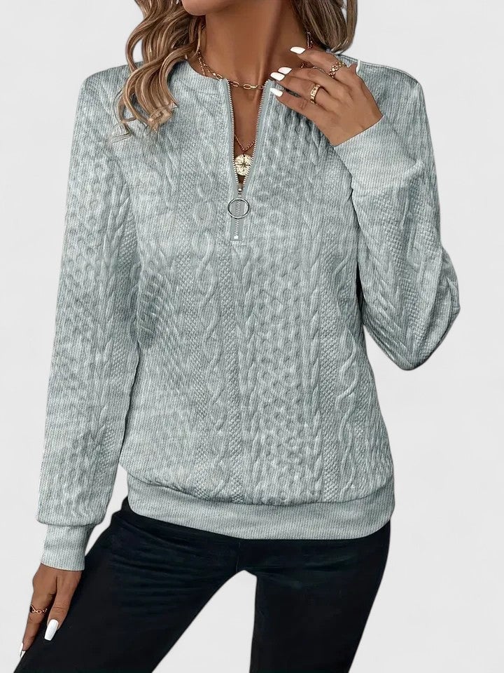 Close-up front view of the Elise sophisticated sweater in white, highlighting its soft fabric and graceful drape