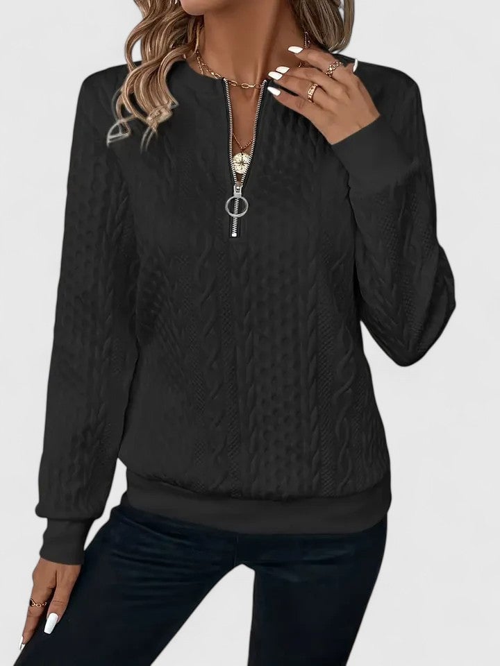 Woman styled in the Elise sophisticated sweater in gray paired with trousers for a polished everyday look