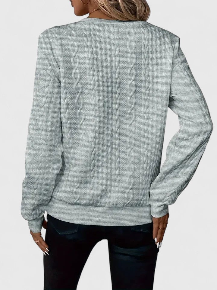Full-length shot of the Elise sophisticated sweater in white, showing its flattering length and drape