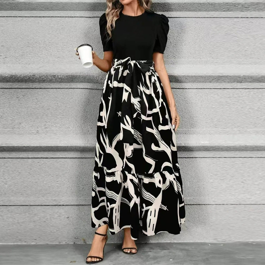 Back view of the Elise puff sleeve floral maxi dress highlighting the fitted solid bodice and flowing skirt