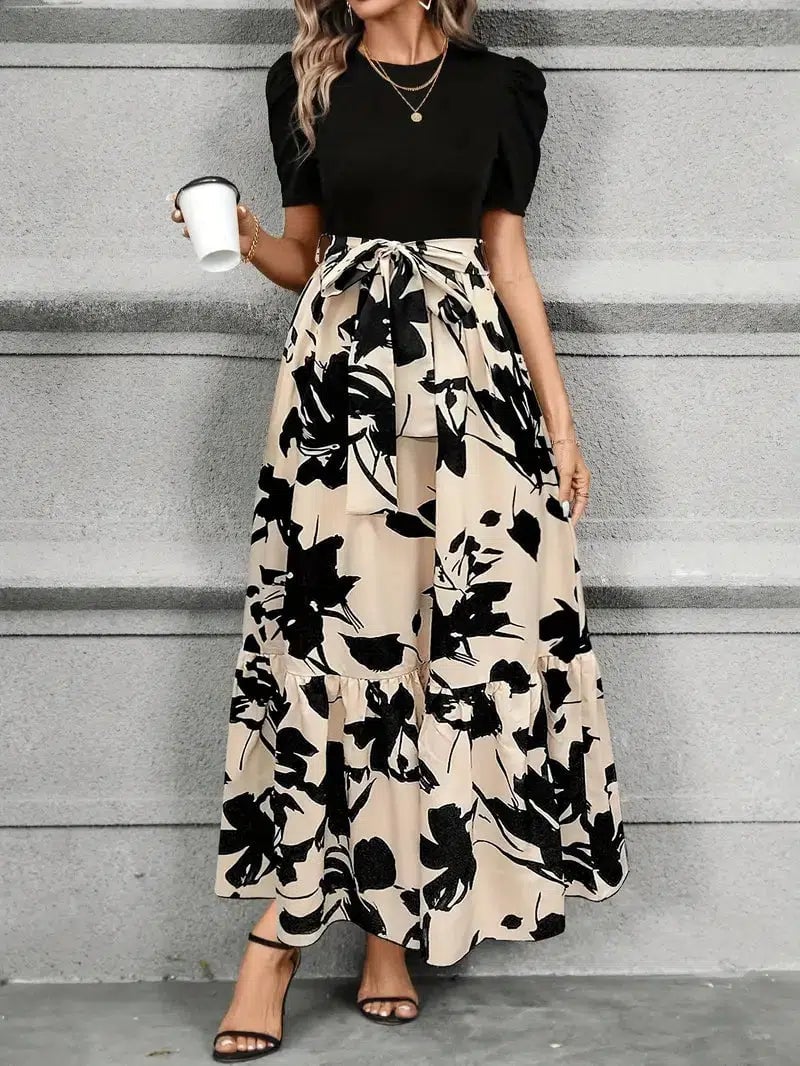 Woman in the Elise floral maxi dress in Olive Leaf Black styled for a summer occasion, full-length front view