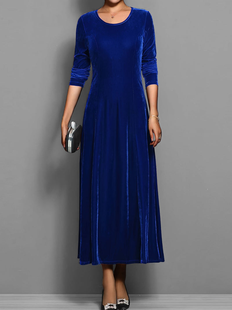 Model wearing the Elizabeth soft velvet A-line dress in blue with a fitted bodice and scoop neckline