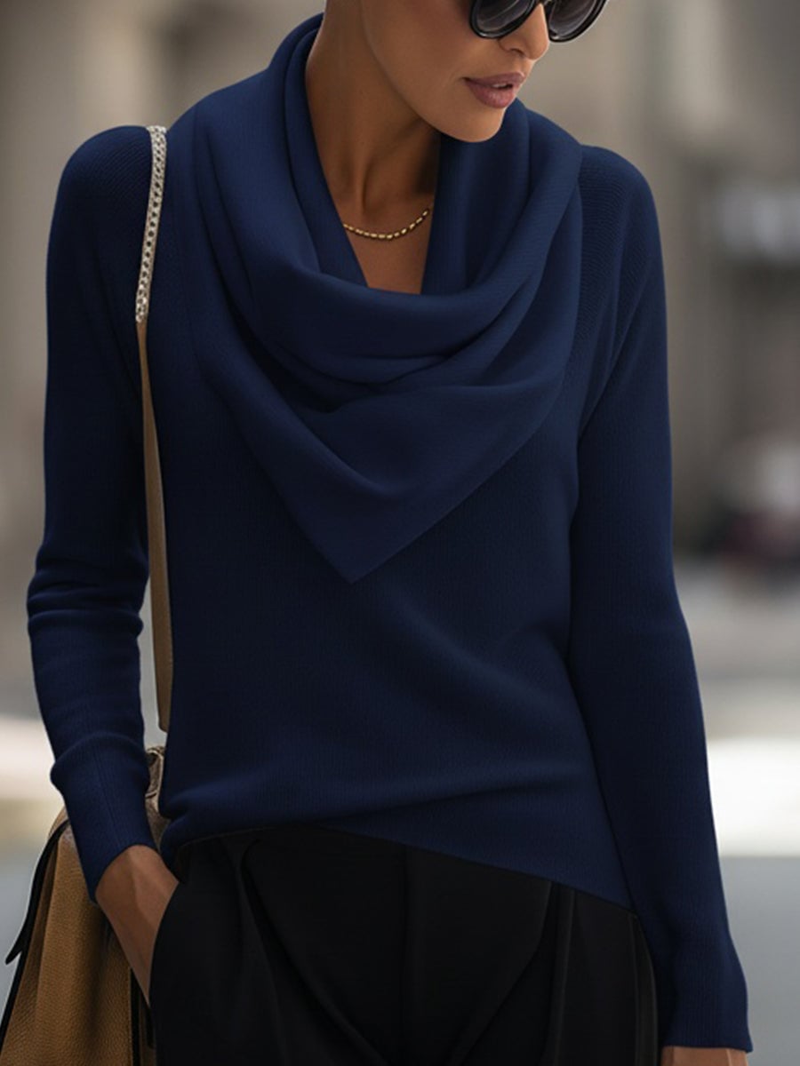 Side profile of a draped cowl neck long-sleeve top in navy blue highlighting the smooth silhouette