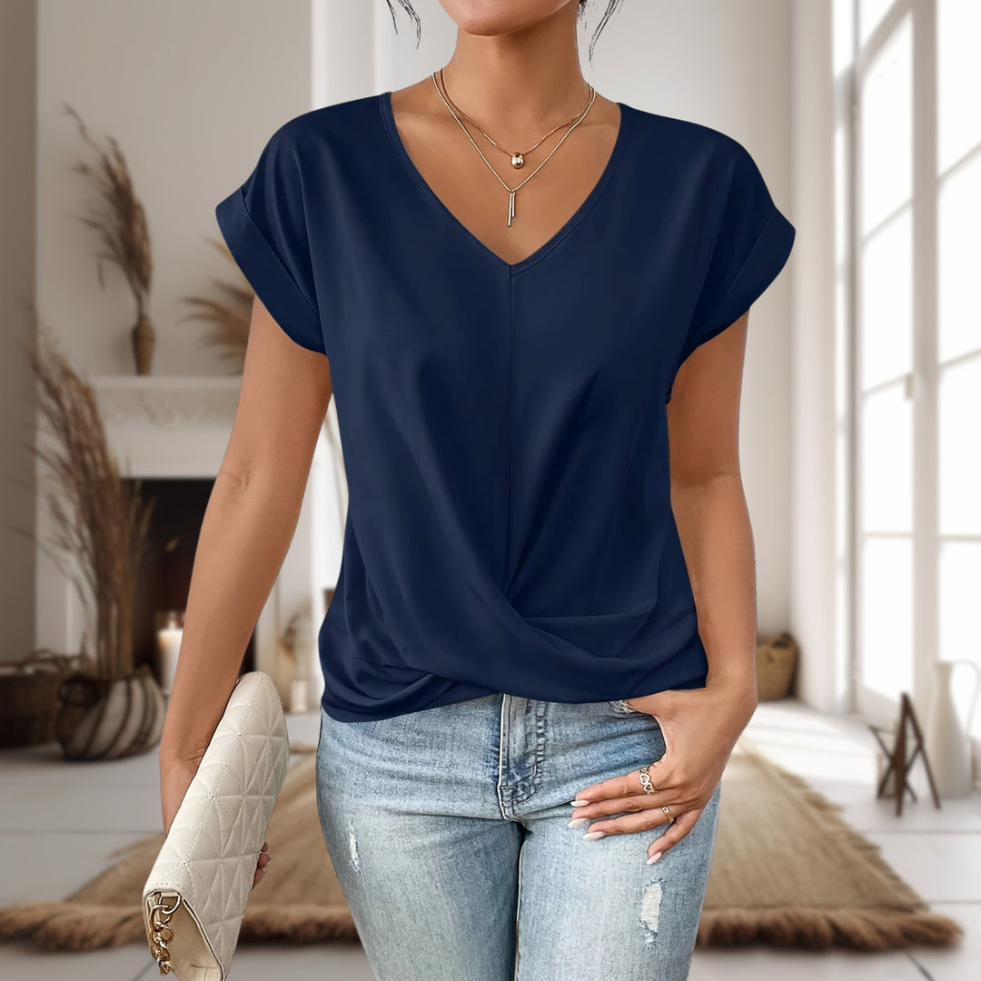 Woman wearing a blue casual sweetheart neck t-shirt styled with shorts for a summer outfit