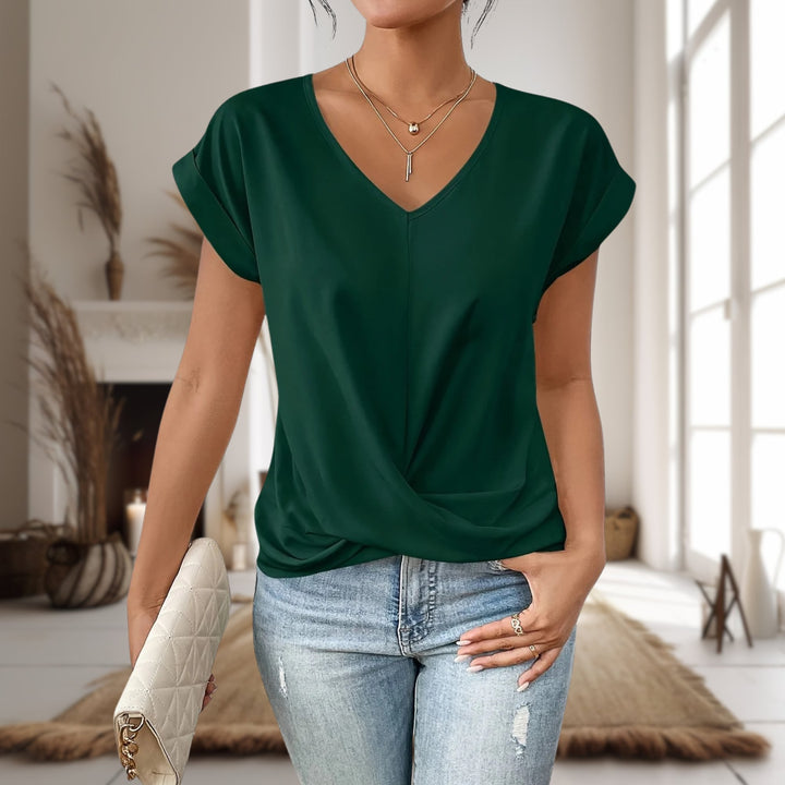 Woman in an apricot sweetheart neck tee layered under a blazer for a smart-casual style