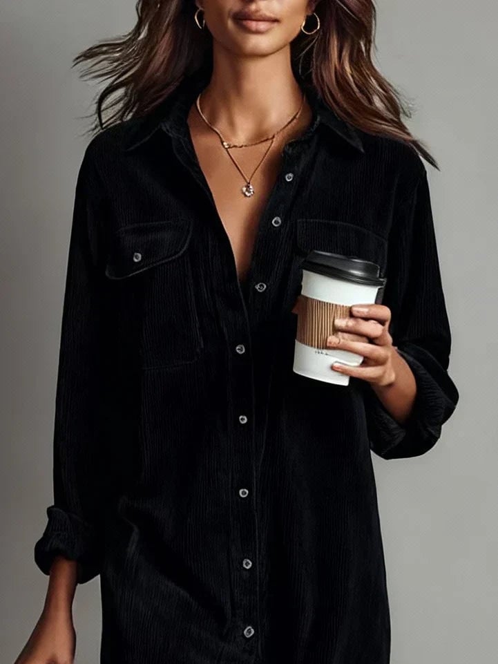 Woman wearing the Elle dress in black styled for an office-ready look