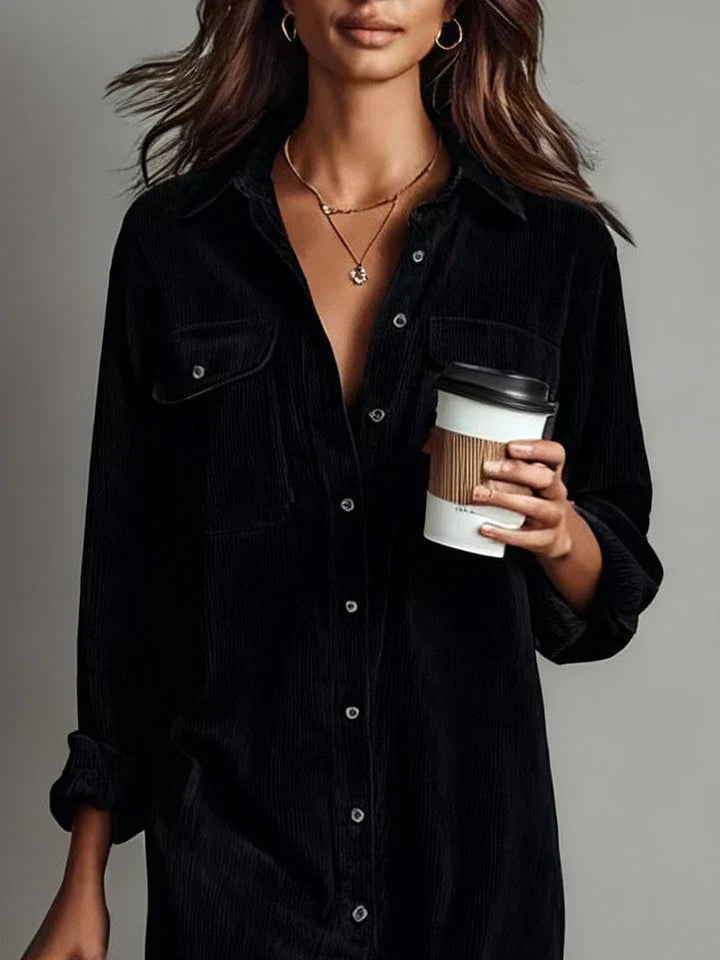 Woman wearing the Elle dress in black styled for an office-ready look