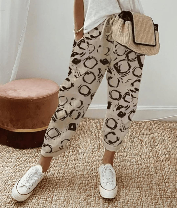 Close-up of breathable floral print trousers showing the smooth waistband and relaxed drape of the fabric