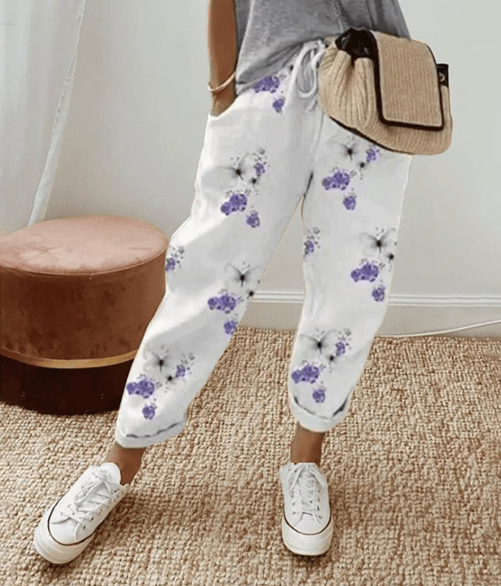 Full-length view of women's comfort waistband trousers styled casually, available in stripes, khaki, and floral print
