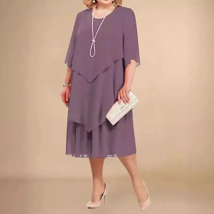 Front view of Ellen chiffon dress in light purple highlighting the asymmetrical overlay and flattering fit