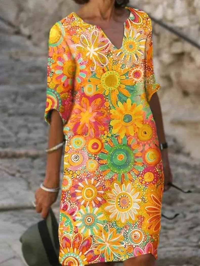 Woman wearing the Ellery floral flowy dress in yellow, featuring a flowing skirt and delicate all-over floral print