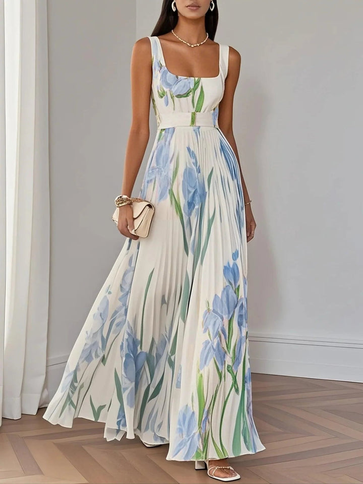 Close-up of delicate pleated detailing on white chiffon maxi dress