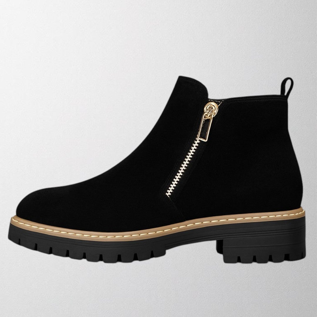 Close-up of the Elma women's shoe showing round toe and side zip fastening in a neutral color