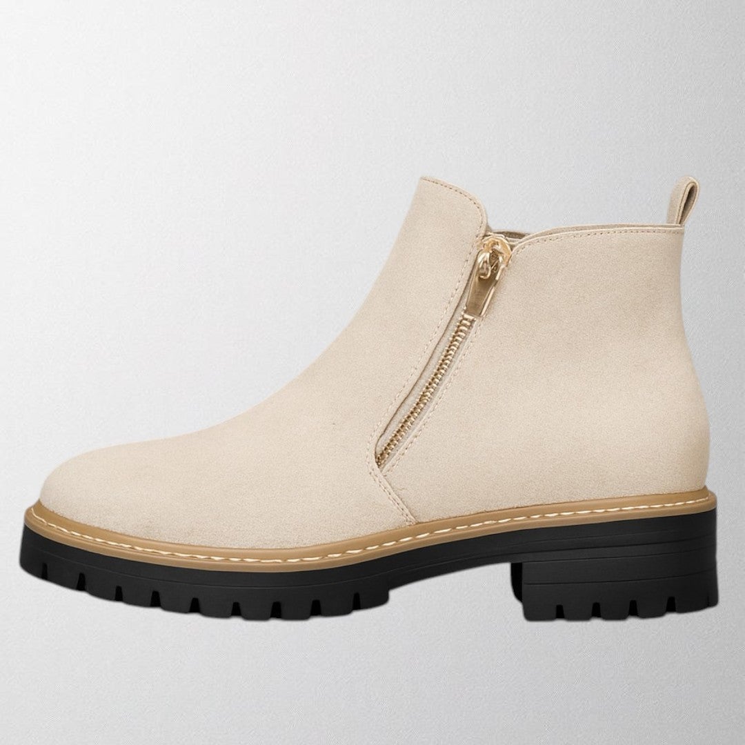 Elma women's shoe displayed at an angle to show the side zip detail and smooth upper