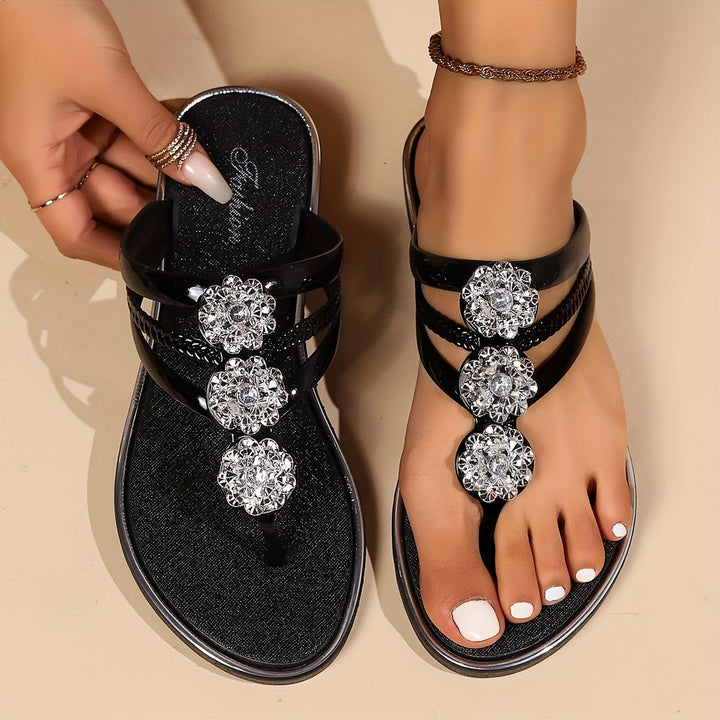 Close-up of rhinestone strap detail on Eloira glam sandals in silver