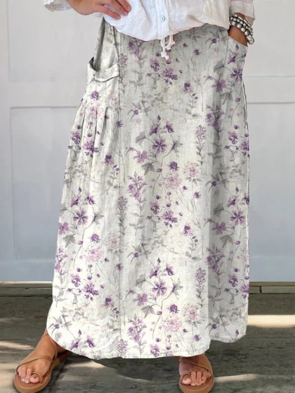 White vintage floral A-line skirt with elastic waistband and side pockets, shown flat on a light background