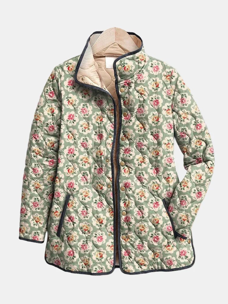Woman wearing a lightweight multicolor floral art print quilted jacket with a relaxed, flattering fit