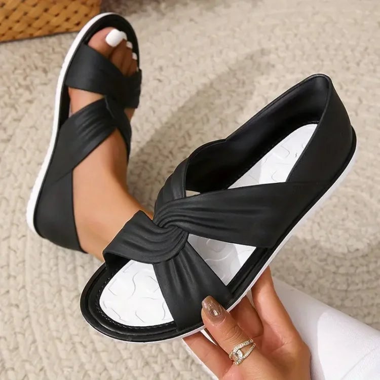 Side view of Eloise sandals in apricot showing knot strap design