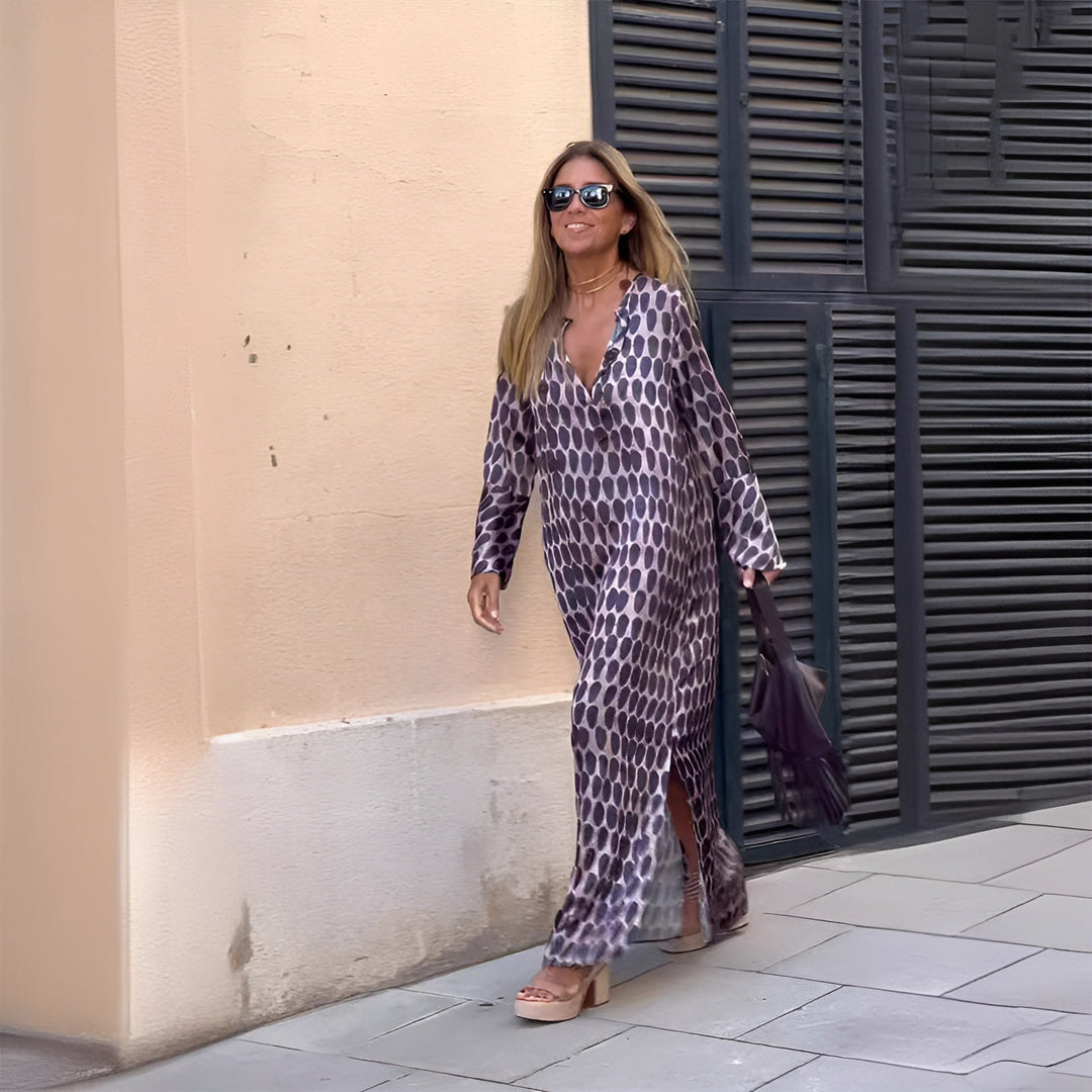 Woman wearing the Eloise flowy boho printed dress in purple, featuring a softly defined waist and lightweight flowing skirt